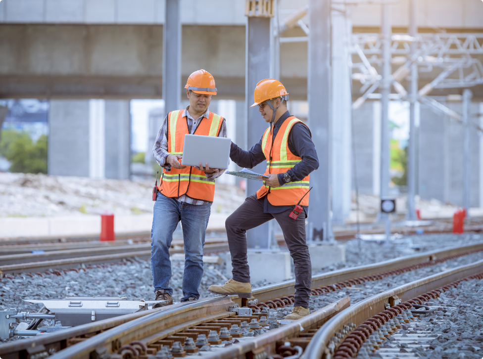 two contstruction workers on a laptop.png